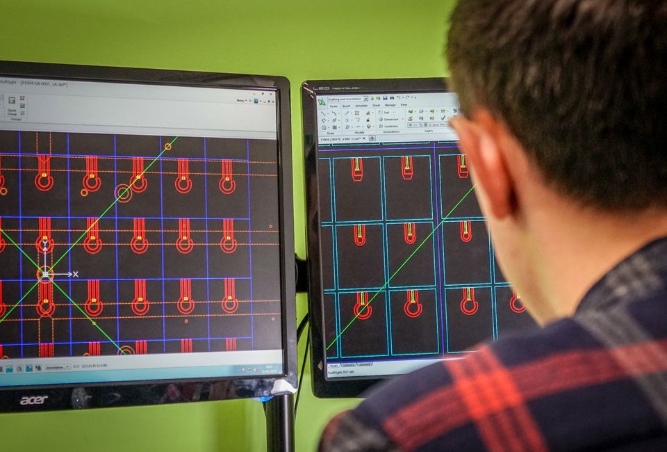 Engineer reviewing electrode layout designs